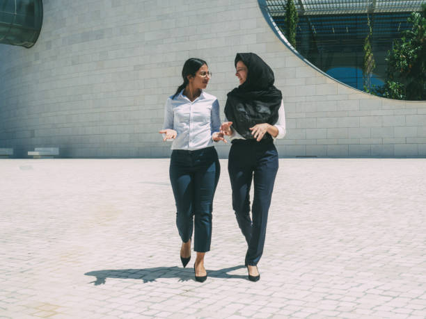 istock Multicultural female business colleagues discussing project 1209807535