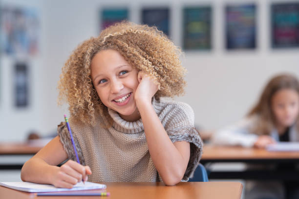 istock Portrait of an elementary age student at her desk in school 1209808015