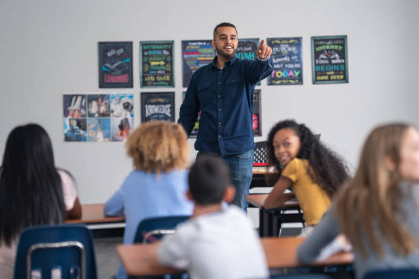 istock A male teacher in a junior high classroom setting 1209808017