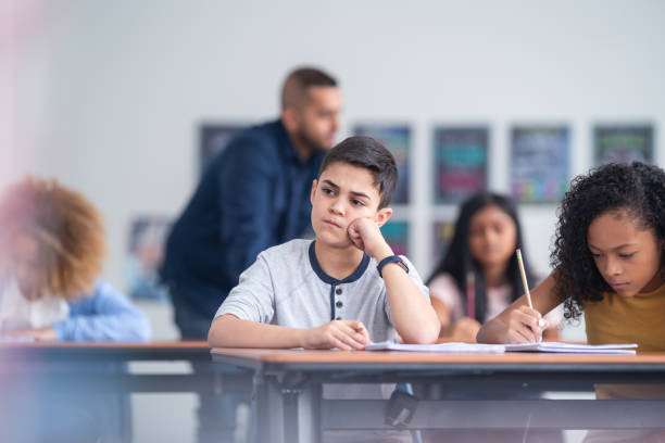 istock A young student appears distracted as he completes and exam 1209808018