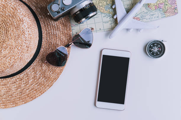 istock Empty screen smart phone with travel accessories and items on white background with copy space, Travel concept 1209808035