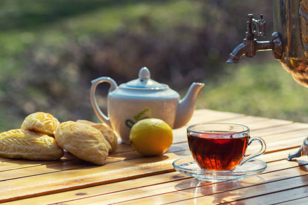 Cup of fragrant black tea on a table in the garden