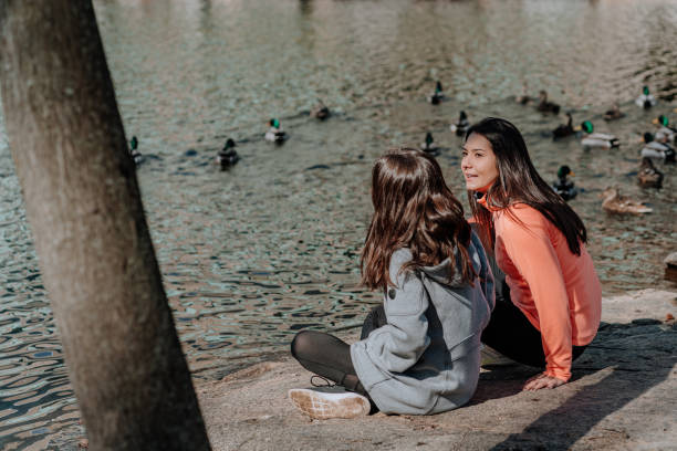 istock Sisters close to a lake having a good time 1209809147