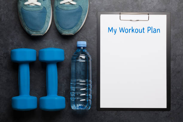 istock Fitness equipment and sheet for workout plan 1209812421