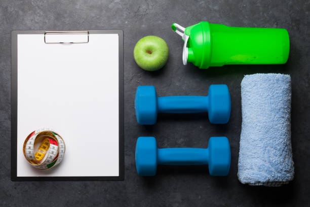 istock Fitness equipment and sheet for workout plan 1209812578