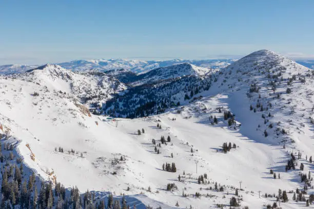 View of mountains, valleys and skyline from top of Hidden Peak in winter at Snowbird Ski Resort in Little Cottonwood Canyon in the Wasatch Range near Salt Lake City, Utah, USA.