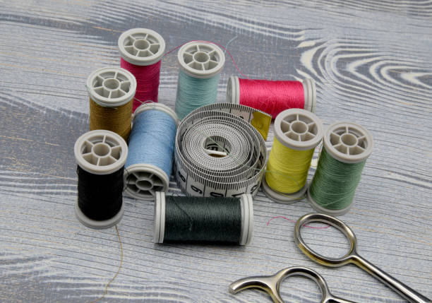 istock sewing accessories on wooden background 1209817378