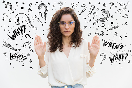 Serious woman in eyeglasses showing stop gesture. Beautiful young lady showing palms. Warning or prohibition concept