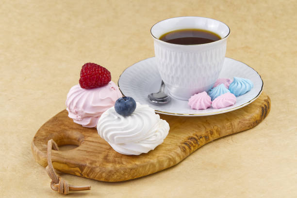 istock white coffee cup with a gold rim - coffee on an olive wood board. breakfast, coffee and bize cookies with raspberries and blueberries 1209817849