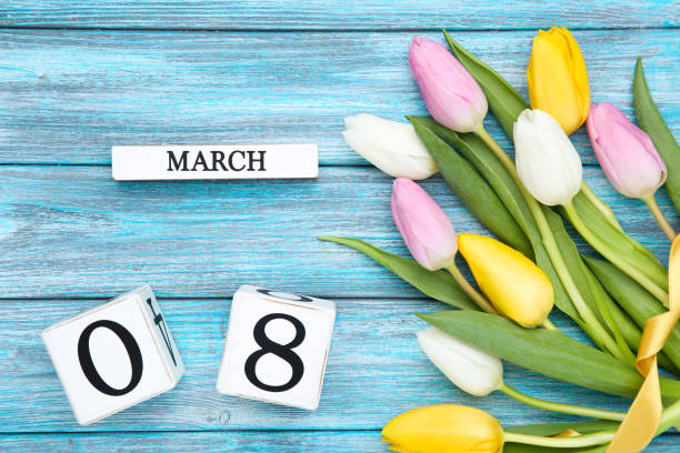 istock White cube calendar with tulip flowers on blue wooden table 1209818645