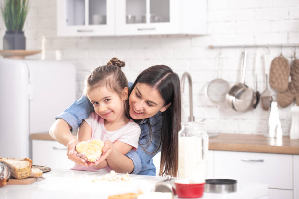 istock Mom and daughter prepare pastries in the kitchen. 1209820165