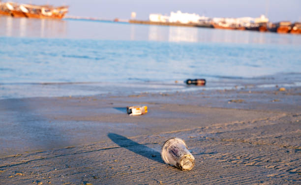 istock Background image with plastic waste in the shore of harbor. 1209820272