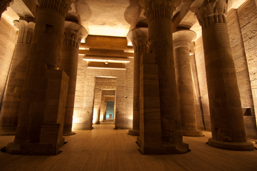 A tourist takes photos at the Kom Ombo temple in Egypt. This temple is dedicated to the hawk god Horus and the crocodile god Sobek.