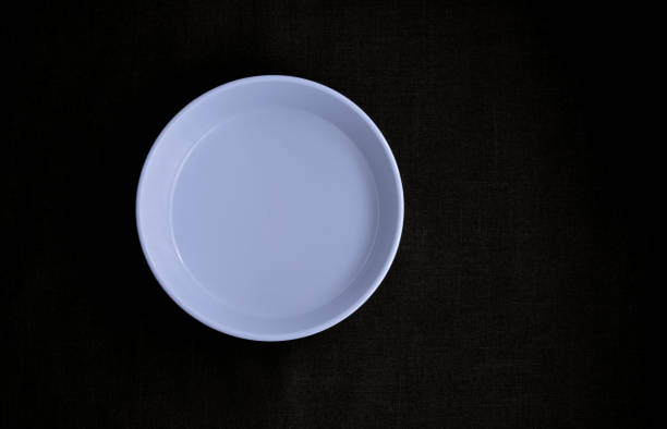 istock bowl violet on clothing black background 1209821252