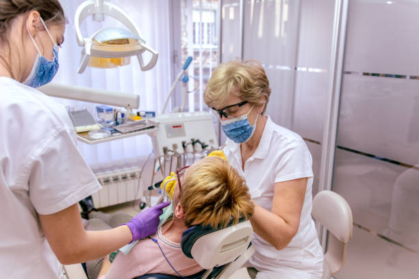 istock Mature woman having teeth examining at dentist 1209822264