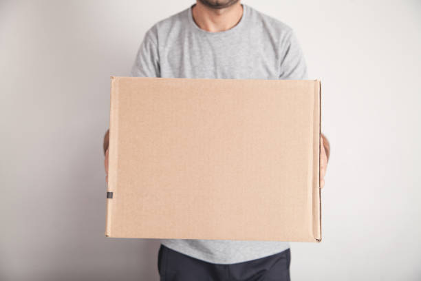 istock Man with a cardboard box. Products, Commerce, Retail, Delivery 1209822295