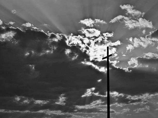 istock Black and white cross silhouette with sun beams 120982296