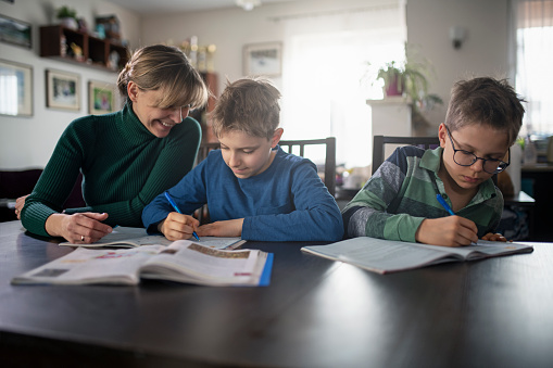 Mother and little boys doing homework at school.
Nikon D850