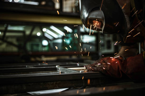 istock Unrecognizable steel worker welding metal in a workshop. 1209827131