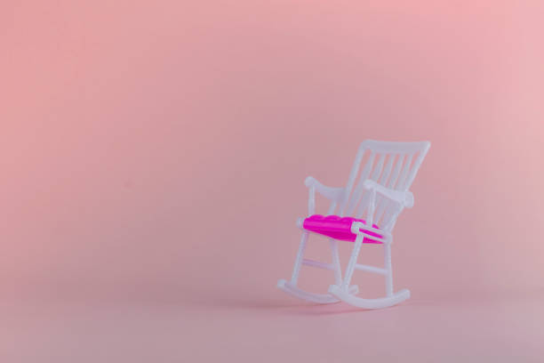 istock Rocking chair on a pink background. Place for text 1209827482
