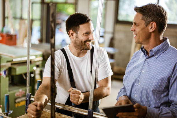 istock Happy manual worker and his manager talking in a workshop. 1209827751