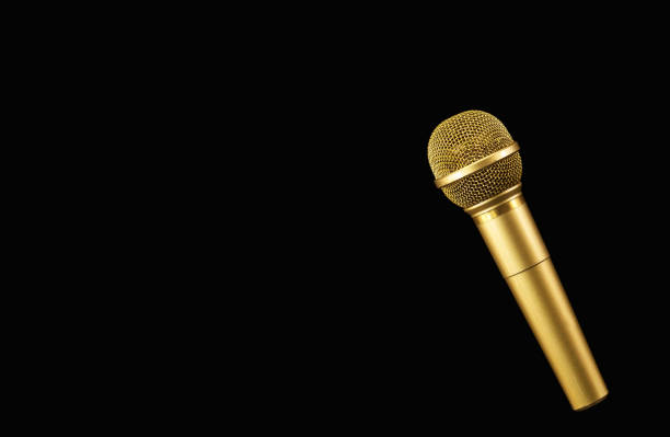 Golden microphone on black background. stock photo