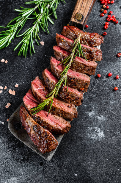 istock Grilled top blade, Denver steak. Marble meat beef. Black background. Top view 1209829393