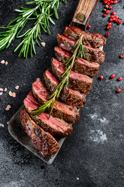 Grilled top blade, Denver steak. Marble meat beef. Black background. Top view Grilled top blade, Denver steak. Marble meat beef. Black background. Top view. blade roast stock pictures, royalty-free photos & images
