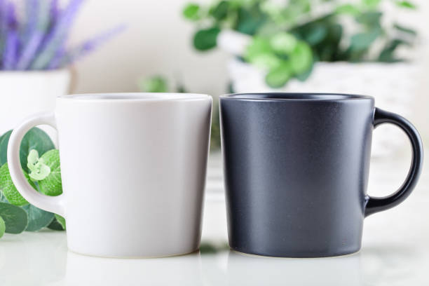 istock White and black mugs on a background of flowers . Mock up. Template Space for Creative Artwork Lettering Text Product Promotion Branding. Elegant style. 1209829520