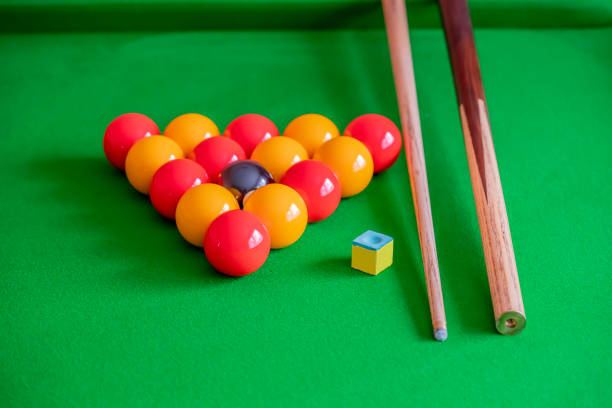 istock Pool balls arranged in a triangle, wooden pool cue and cue chalk on a pool table 1209829774