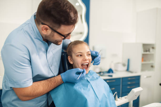 istock Dentist examining a patient's teeth in dentist office 1209829941