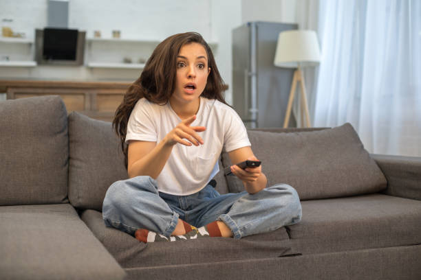 Pretty young lady watching movie at home