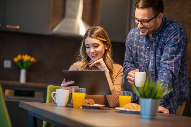 istock Young couple with laptop at home 1209831140