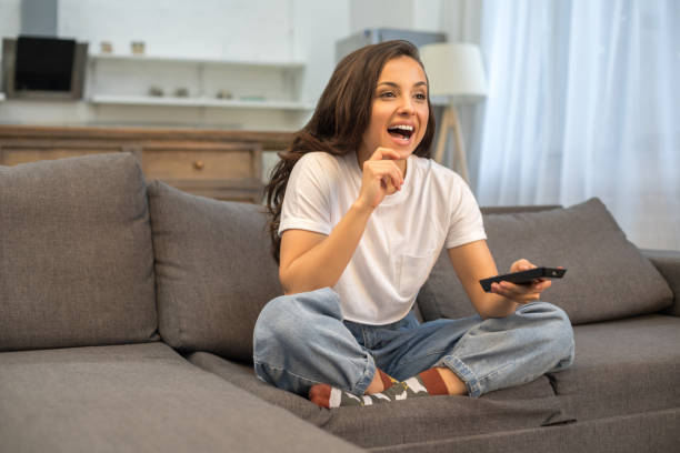 istock Young joyful woman resting on sofa at home 1209831697