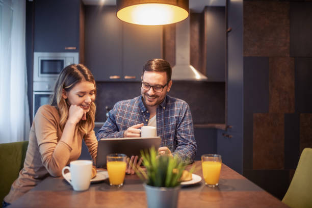 istock Young couple with laptop at home 1209832004