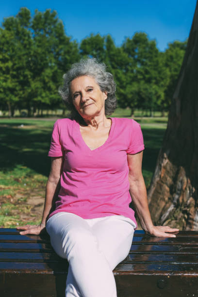 istock Peaceful old lady posing in park 1209832179
