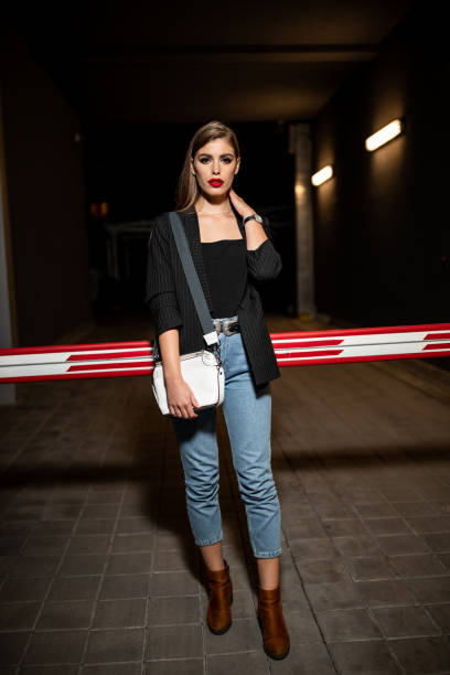 istock Young beautiful woman outdoors at night 1209832619