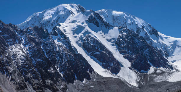 istock Snowy mountain peaks on a sunny day 1209832641