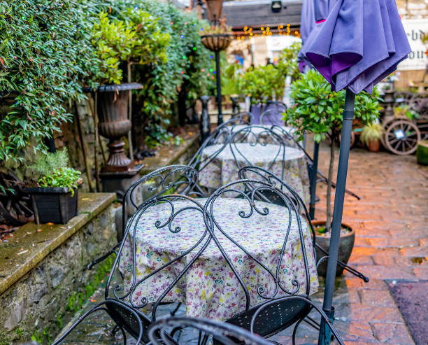 istock Out door tables and chairs in a small courtyard 1209834111