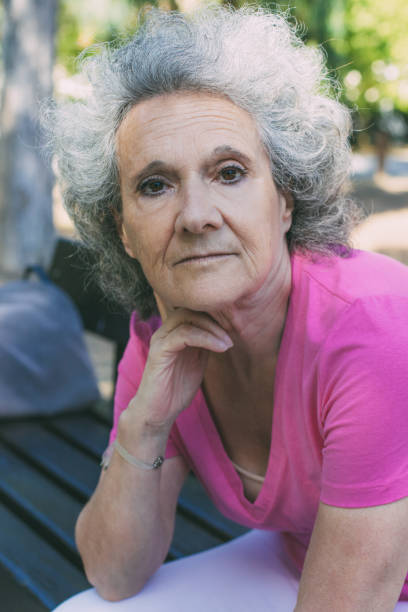 istock Serious old lady relaxing in park 1209834241