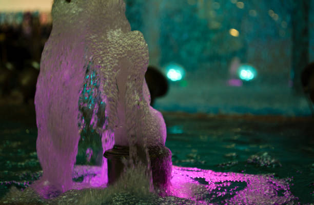 istock Blurred water background. Backlit water jet in the fountain. 1209839801