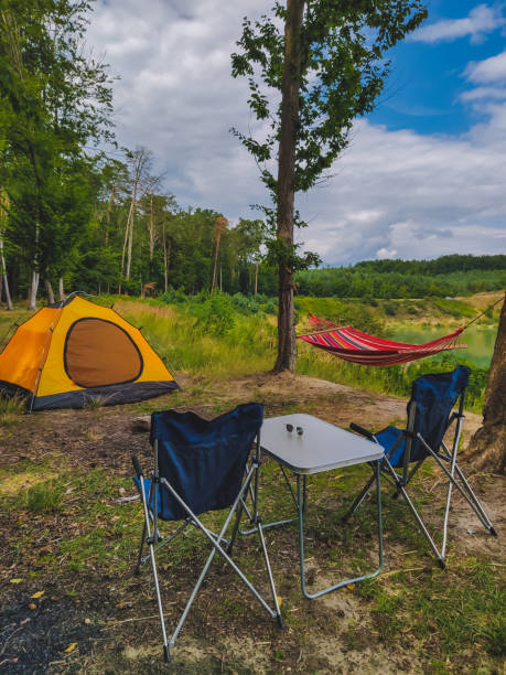istock camp at forest hammock with tent and portable chairs 1209840616