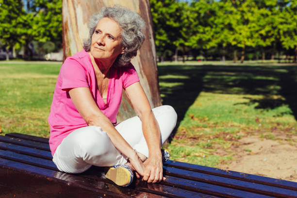istock Serious old lady waiting someone in park 1209840692