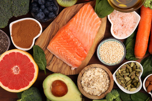 istock Healthy food clean eating selection: fish, fruit, vegetable, cereal, leaf vegetable on rustic background 1209840698