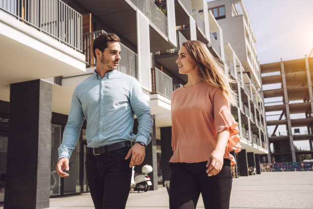 istock man and woman walking on footpath during sunny day 1209841024