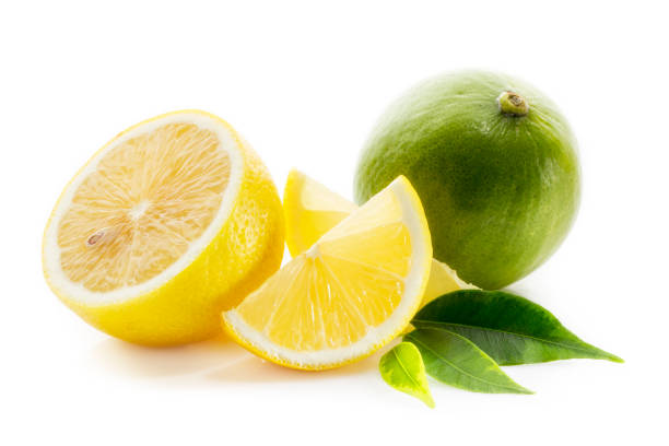 istock Fresh lime, lemon cut in half and into pieces, with green leaves isolated on a white background 1209841310