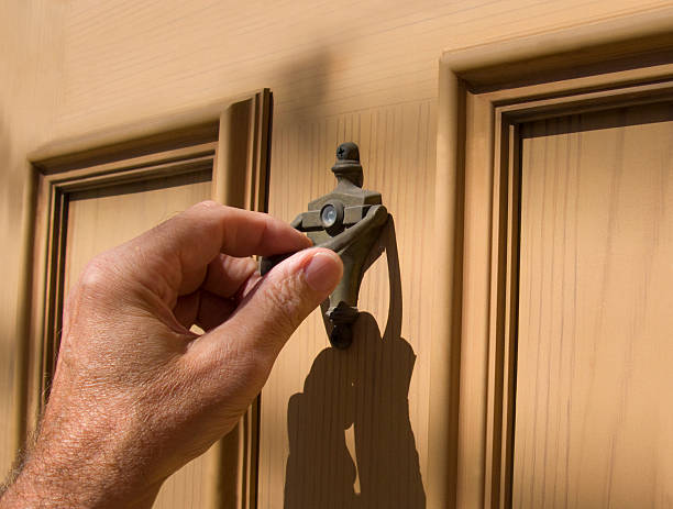 hand on door knocker stock photo