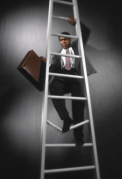 business man on broken ladder stock photo