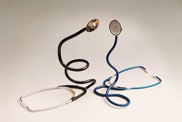 Two stethoscopes standing like snakes and simulating a fight stock photo