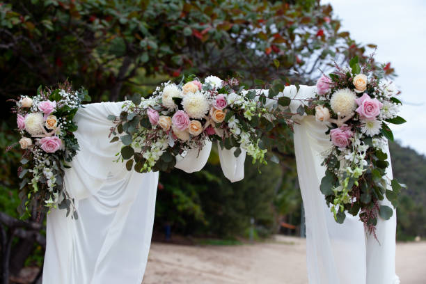 A beach themed wedding arbour with star fish and pink roses